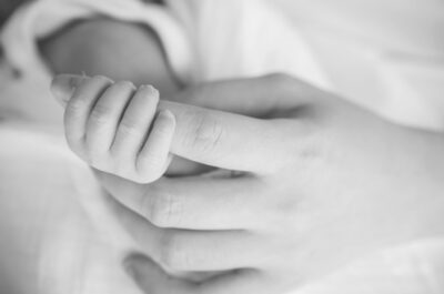 Mother and baby holding hands. Stock image. 