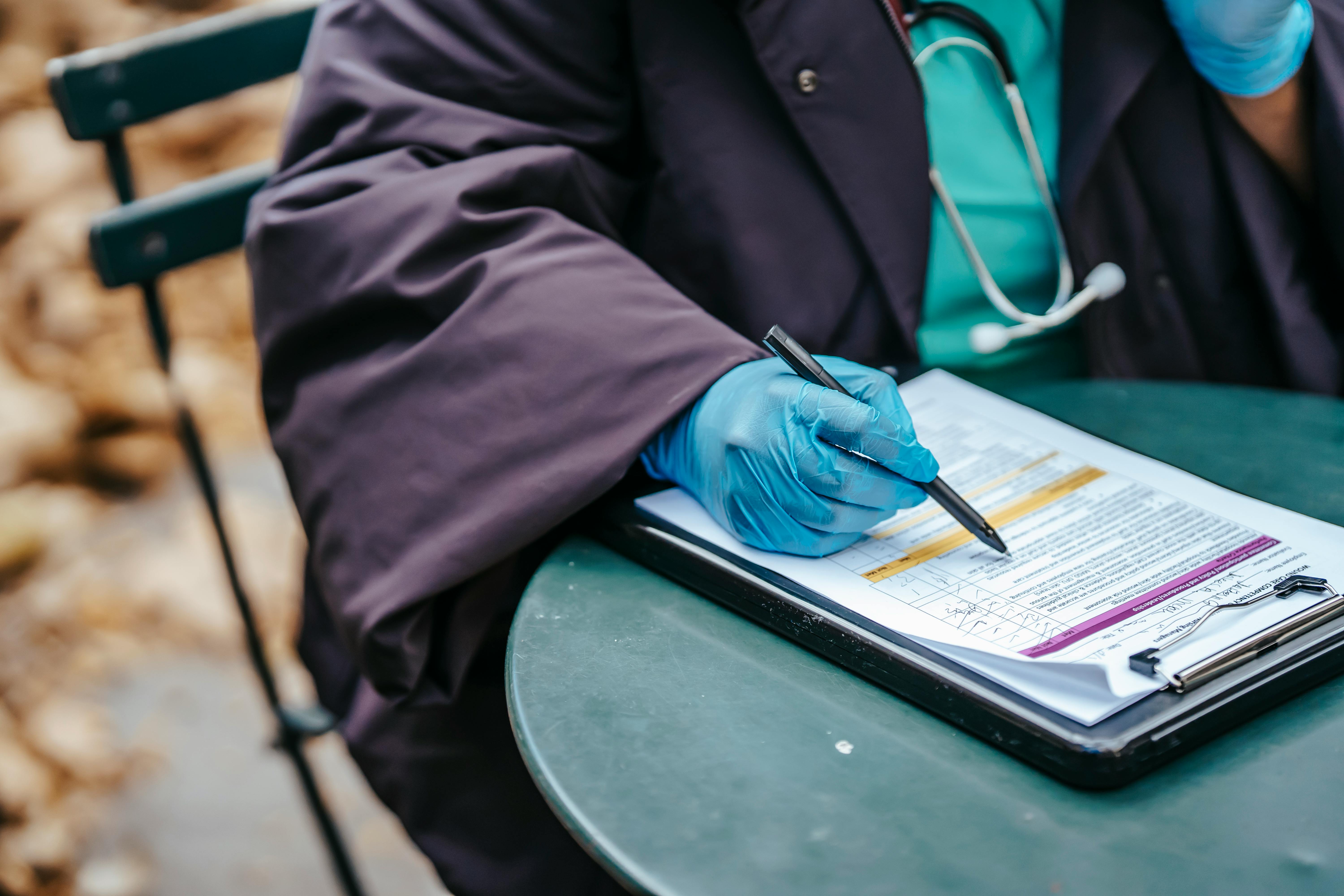 Doctor writing on a clipboard