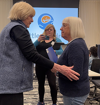 Patty Murray and Dr. Mary Claire King shaking hands