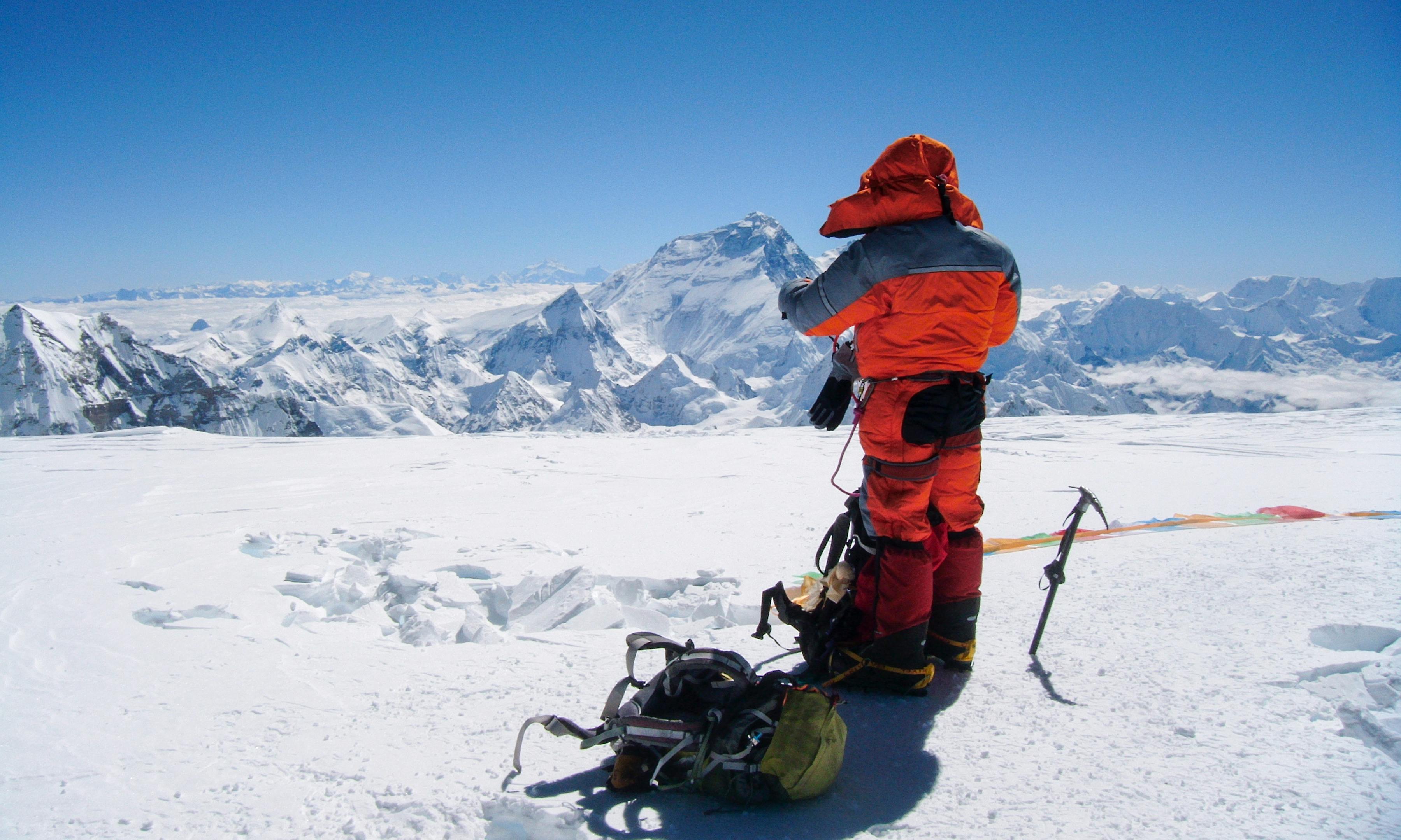Khumjung, Tibet, Nepal. A man in winter lothes hiking a snow covered mountain. Courtesy Infinity Adventure Nepal.