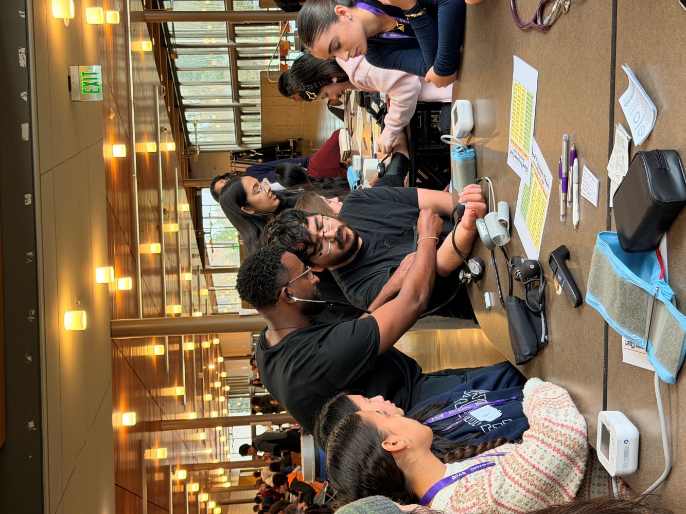 students practicing with blood pressure cuffs