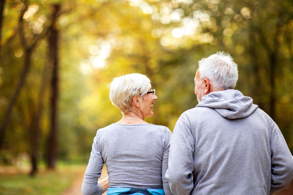 An older man and woman on a walk outside