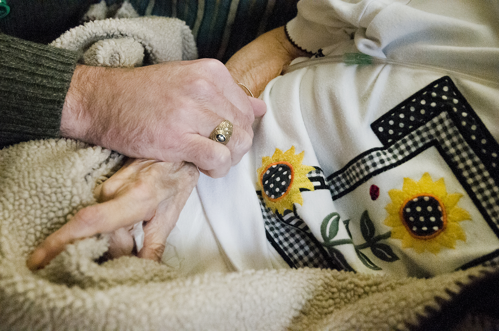 older patient being comforted with hand on arm.