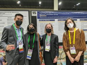 (L-R) Drs. Anders Chen, Geetanjali Chander, Amy Kennedy, and Judith Tsui pause for a photo while perusing posters. Photo courtesy of Geetanjali Chander.