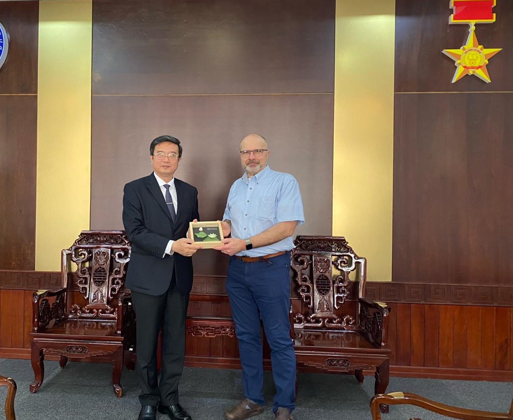 Owens receiving a gift from the University Rector for his support of palliative care at the university and central Vietnam.