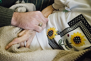 elderly patient holding hands