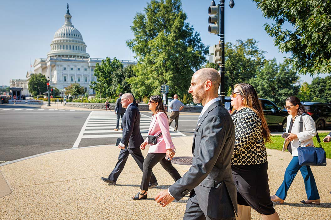 Dr. Joshua Hill, center, and a contingent of doctors and government relations experts from Fred Hutch prepare their messaging while walking to a series of meetings with lawmakers on Capitol Hill, September 11, 2024, in Washington D.C. Photo by Robert Hood / Fred Hutch News Service