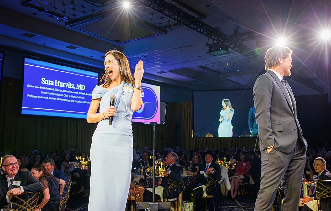 Clinical Research Division Director Dr. Sara Hurvitz is elated after Rob Lowe, the actor, welcomes Hurvitz to the stage during the 2024 Fred Hutch Gala program, December 7, 2024, in downtown Seattle. Photo by Robert Hood / Fred Hutch News Service