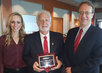 Jim (right) with his dad and sister at the ACP Internist of the Year awards ceremony, 2018.