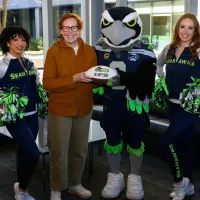 Nora Disis with Seattle Seahawks mascot and cheerleaders. Photo credit: Edwin Hooper/Seattle Seahawks