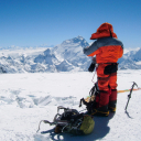 Khumjung, Tibet, Nepal. A man in winter lothes hiking a snow covered mountain. Courtesy Infinity Adventure Nepal.
