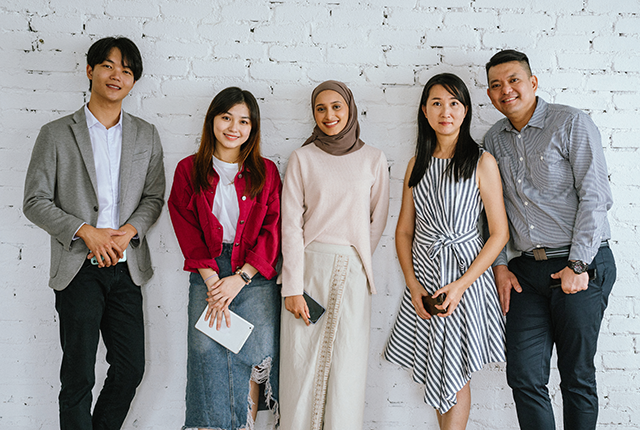 Group of people in front of brick background. Image from: simon2579/Getty Images