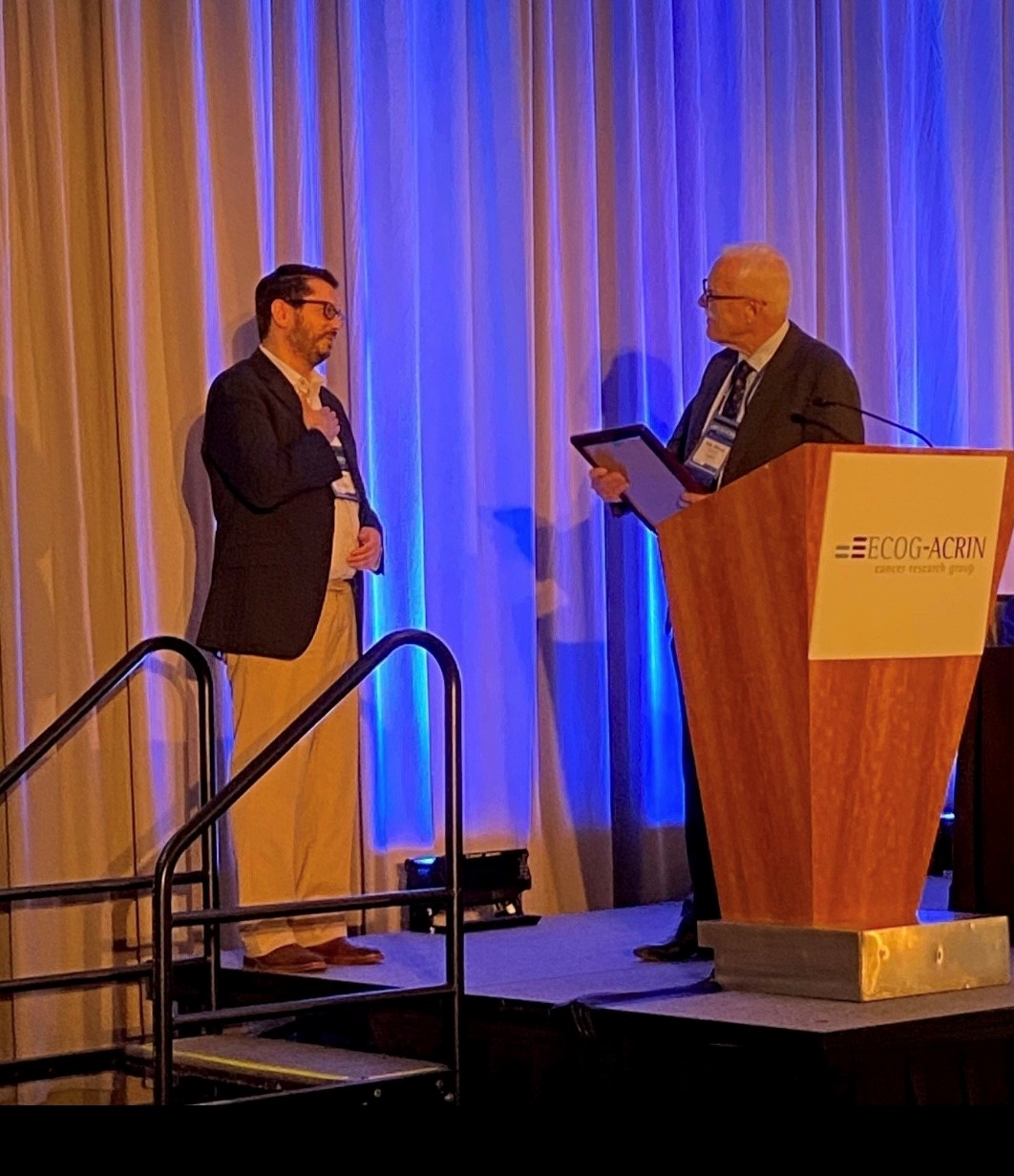 Petros Grivas presented with award on stage 