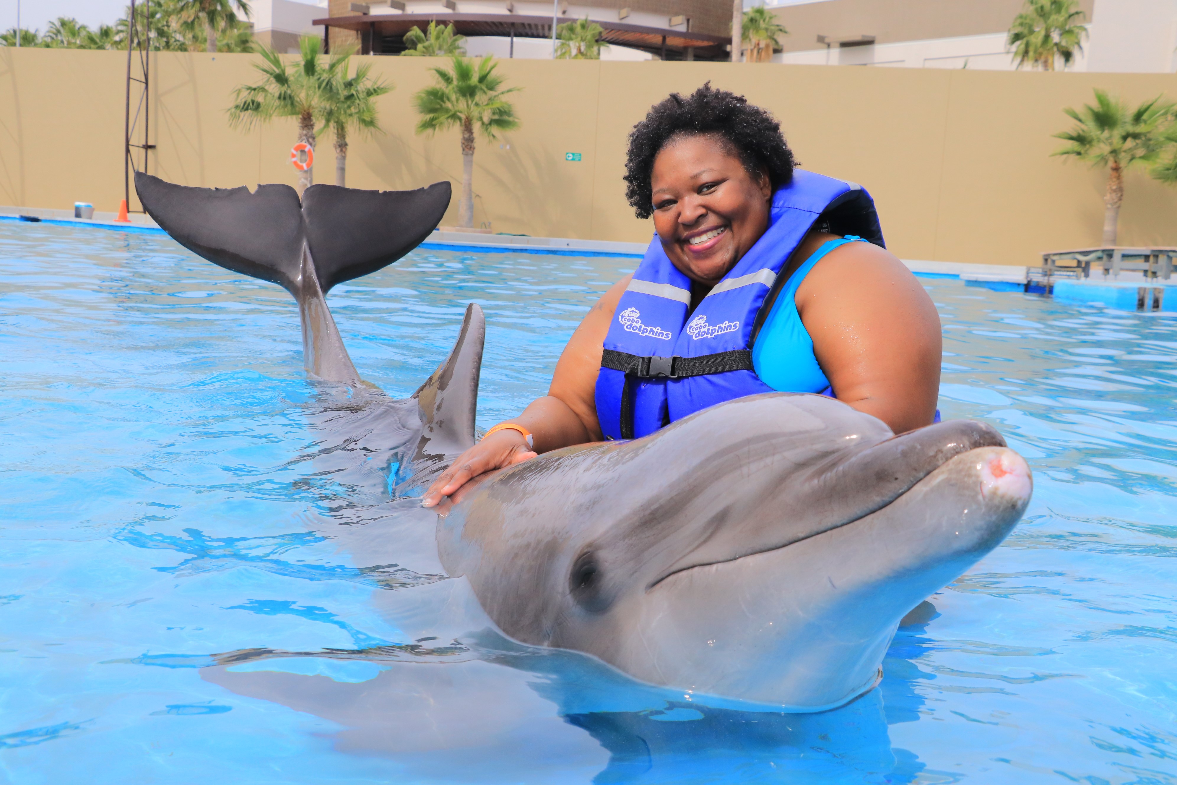Shinetra swimming with dolphins in Cabo, Mexico