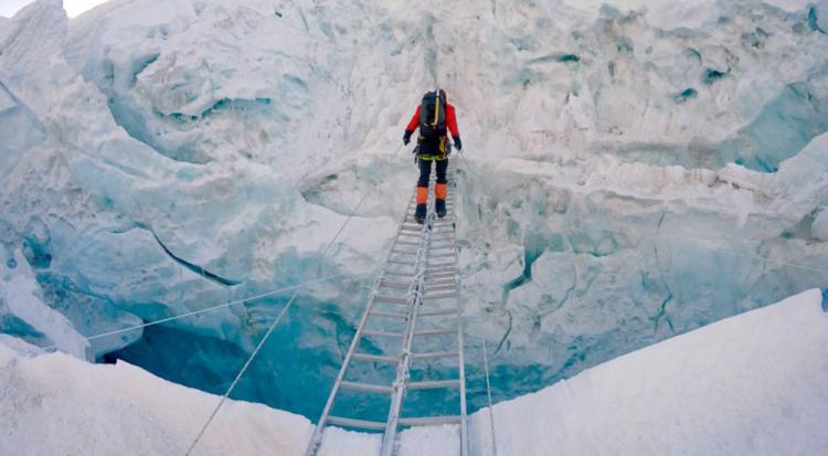 IMG Guide Justin Merle crosses a crevasse. (Photo: Paul Pottinger)