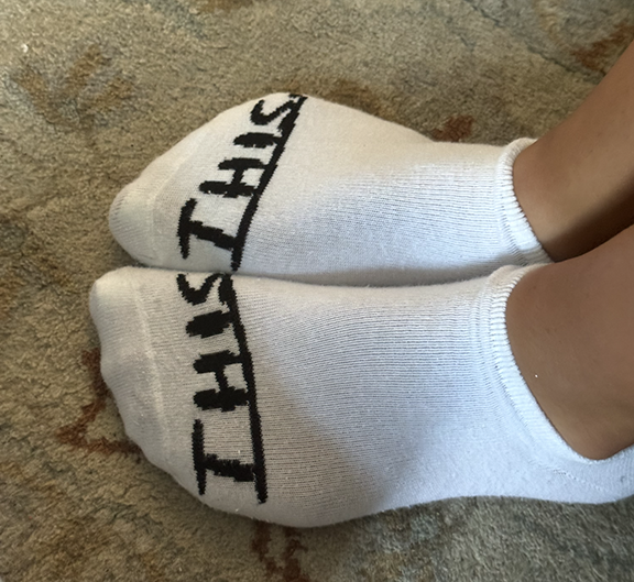 Socks with "this" written on both 